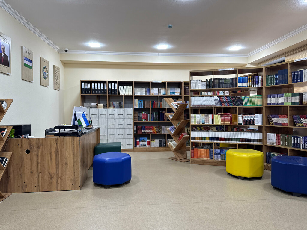 School library with wooden shelves, a desk, and blue and yellow seats